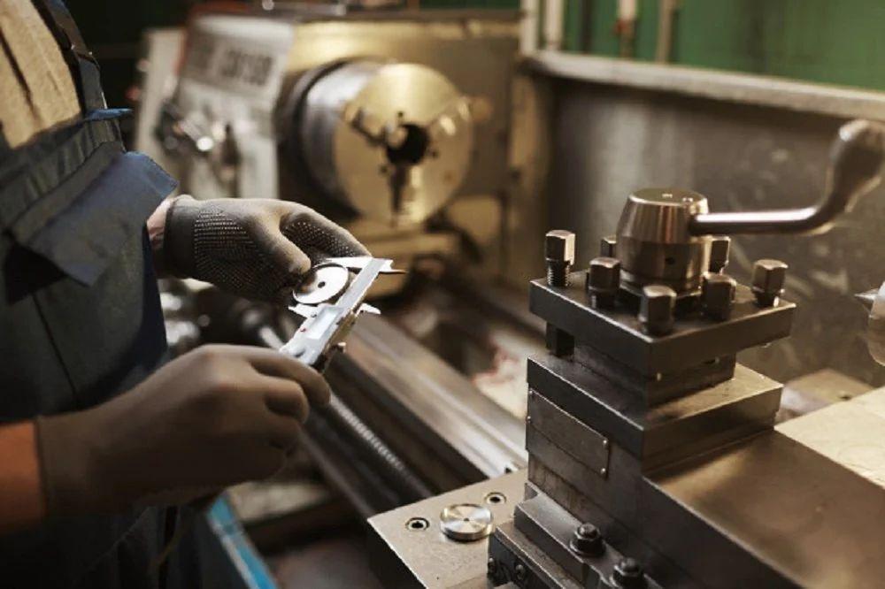 Measuring a machined part at the lathe
